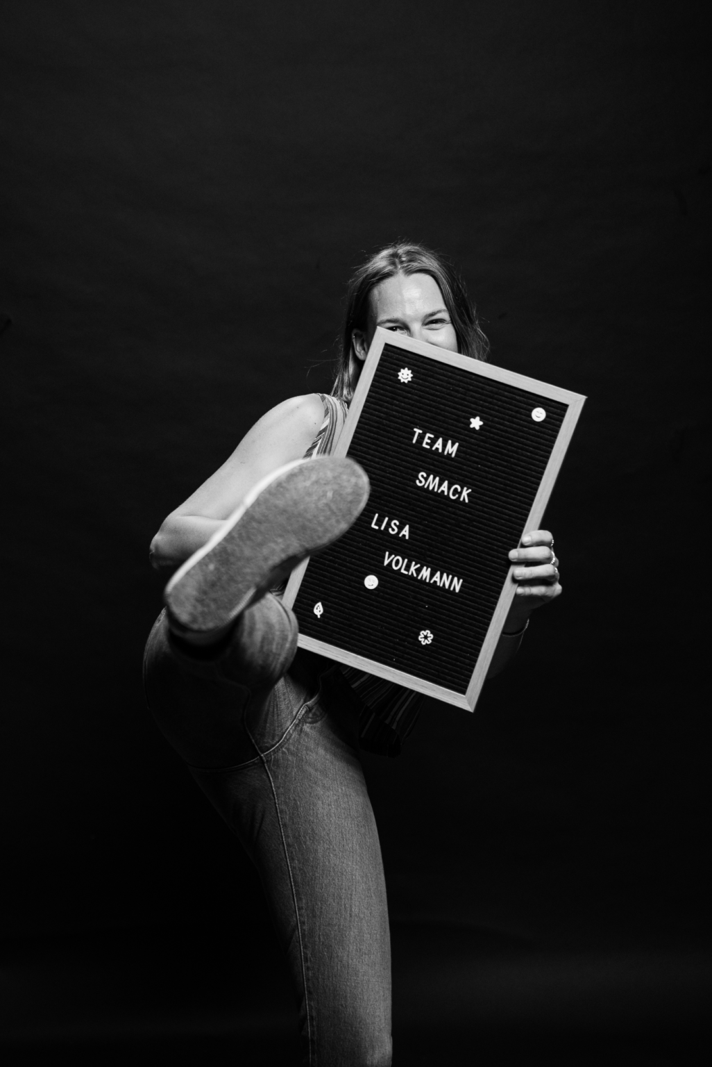 Lisa Volkmann holding her name sign for SMACK Hospitality